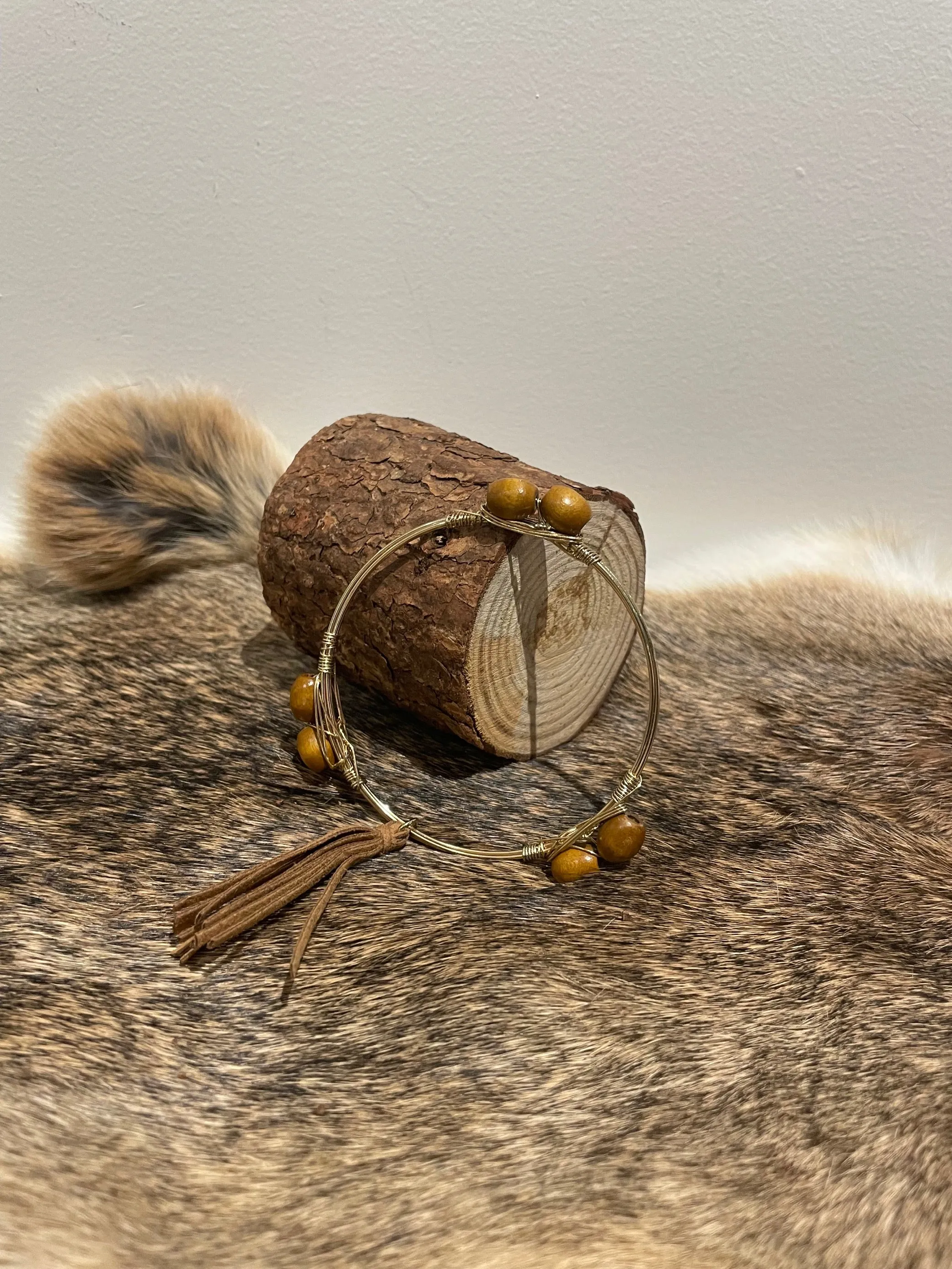 Golden Metal Bracelet with seeds and tassel